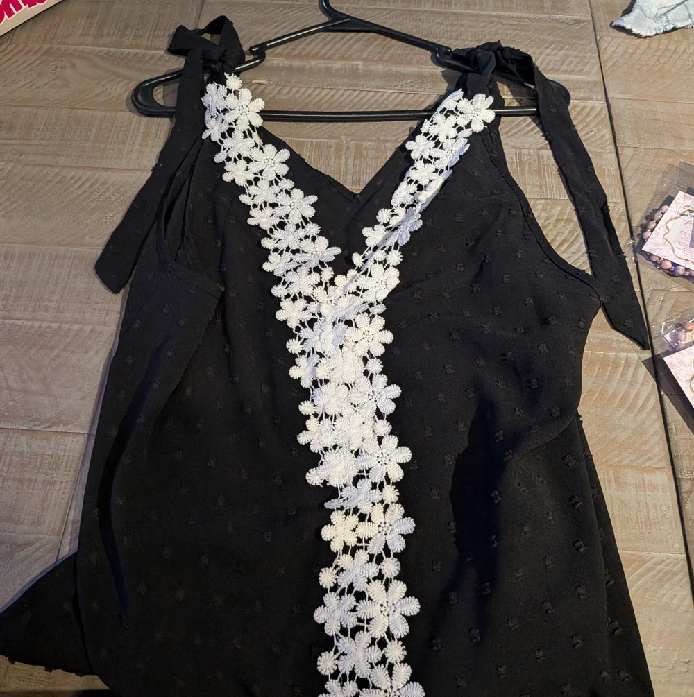 Black Sleeveless Top with White Floral Detail